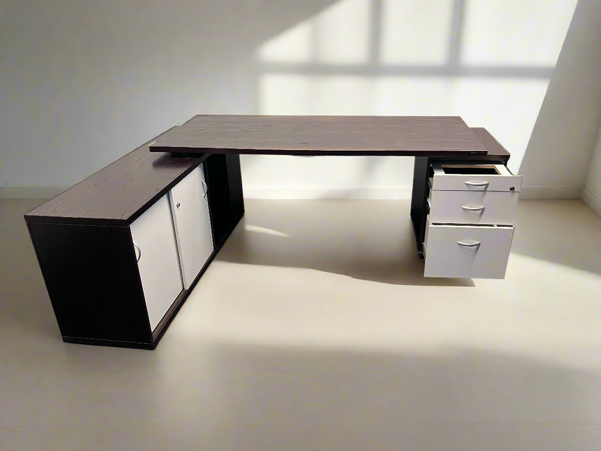 Modern L-shaped desk with storage cabinets on a plain background