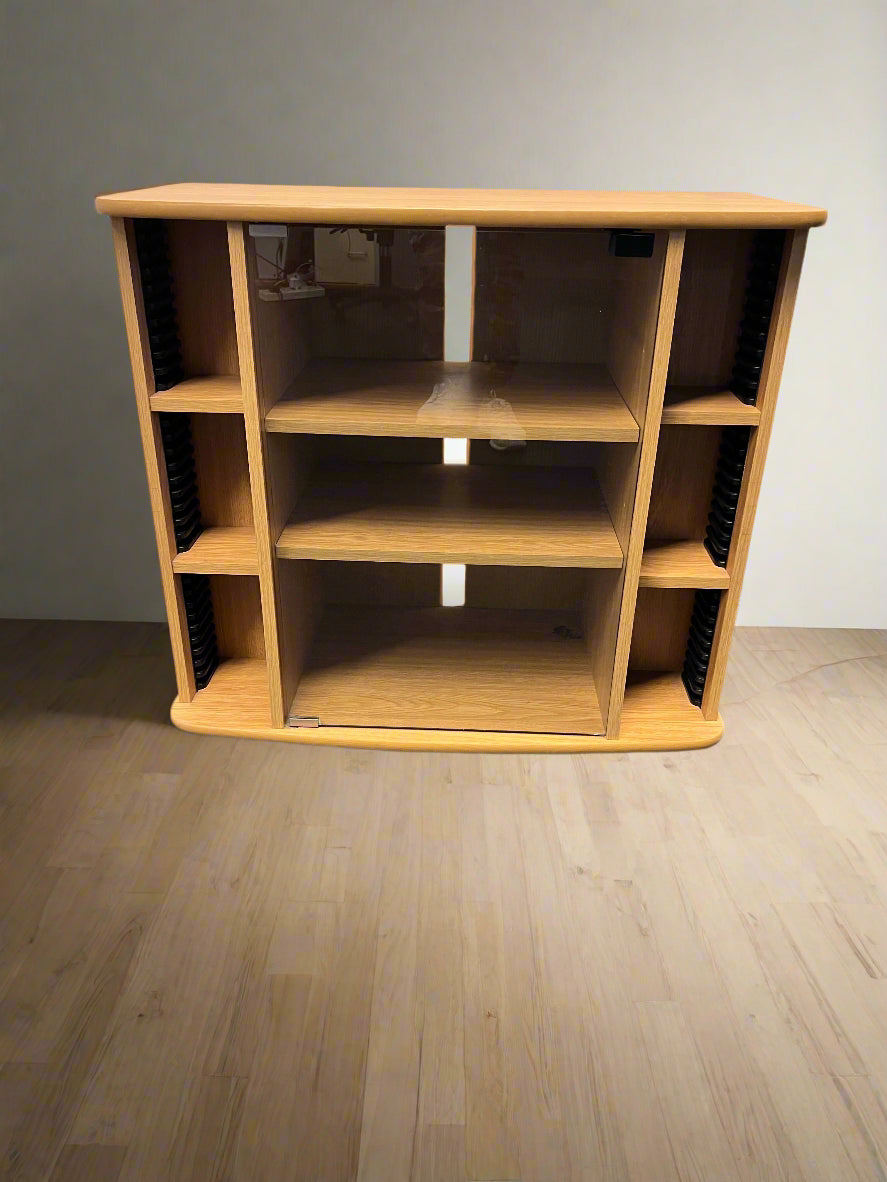 Wooden entertainment center with shelves on a wooden floor.