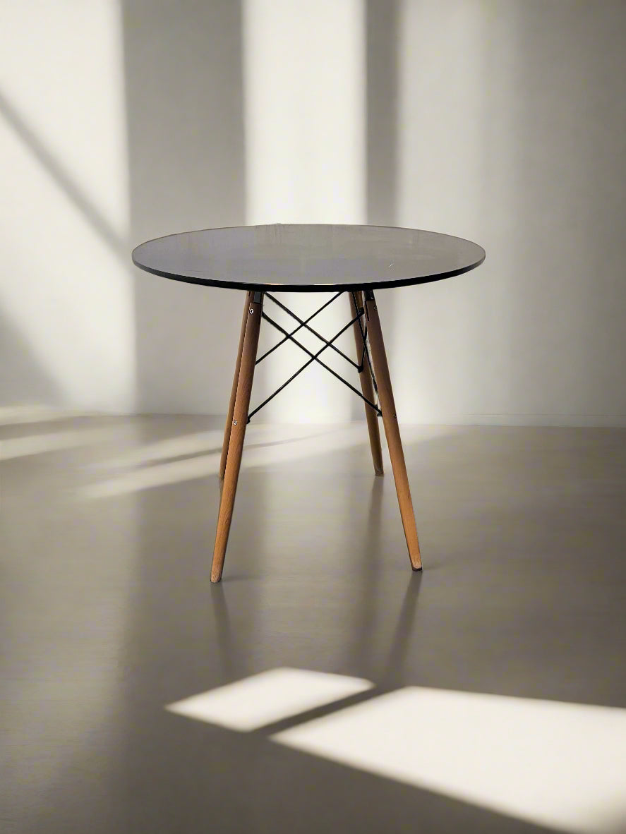 Round table with wooden legs on a neutral background