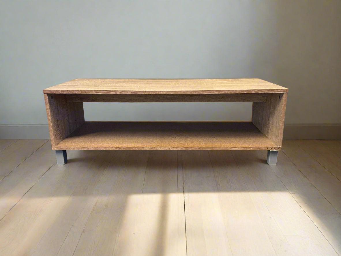 Wooden coffee table with a minimalist design on a wooden floor.