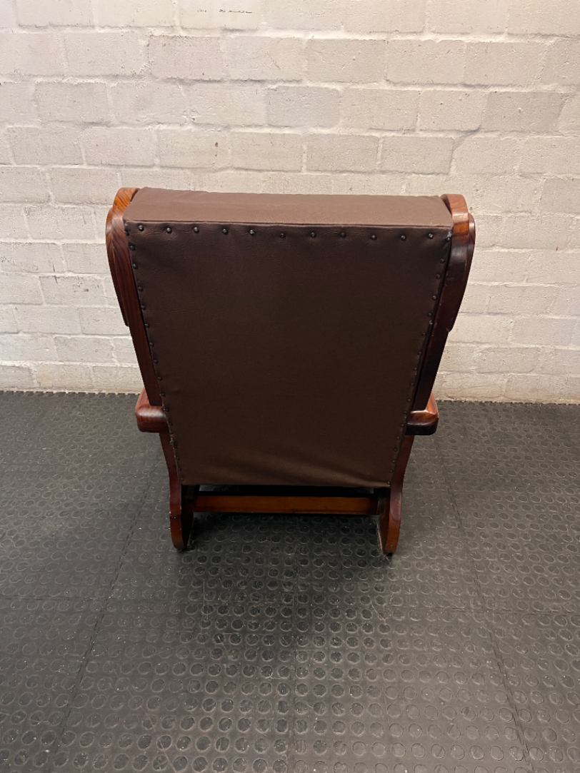 Vintage Brown Vinyl Armchair with Wooden Armrests — Significant Wear and Scratching on Front Edges