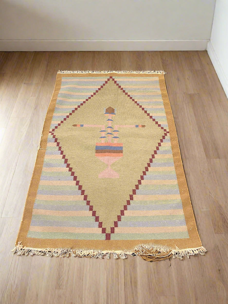 Decorative rug with geometric pattern on a wooden floor