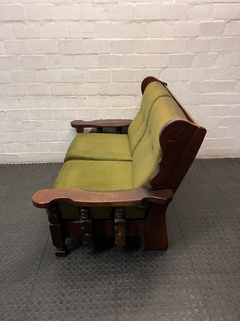 Vintage Style Green Fabric 2 Seater Couch with Wood Frame — Aged State with Scratched Woodwork