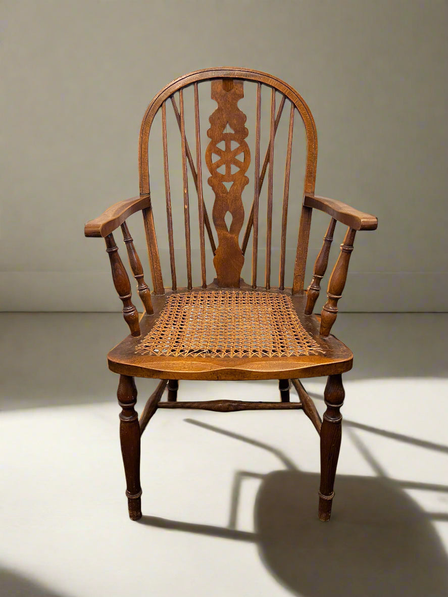 Wooden chair with a woven seat on a plain background