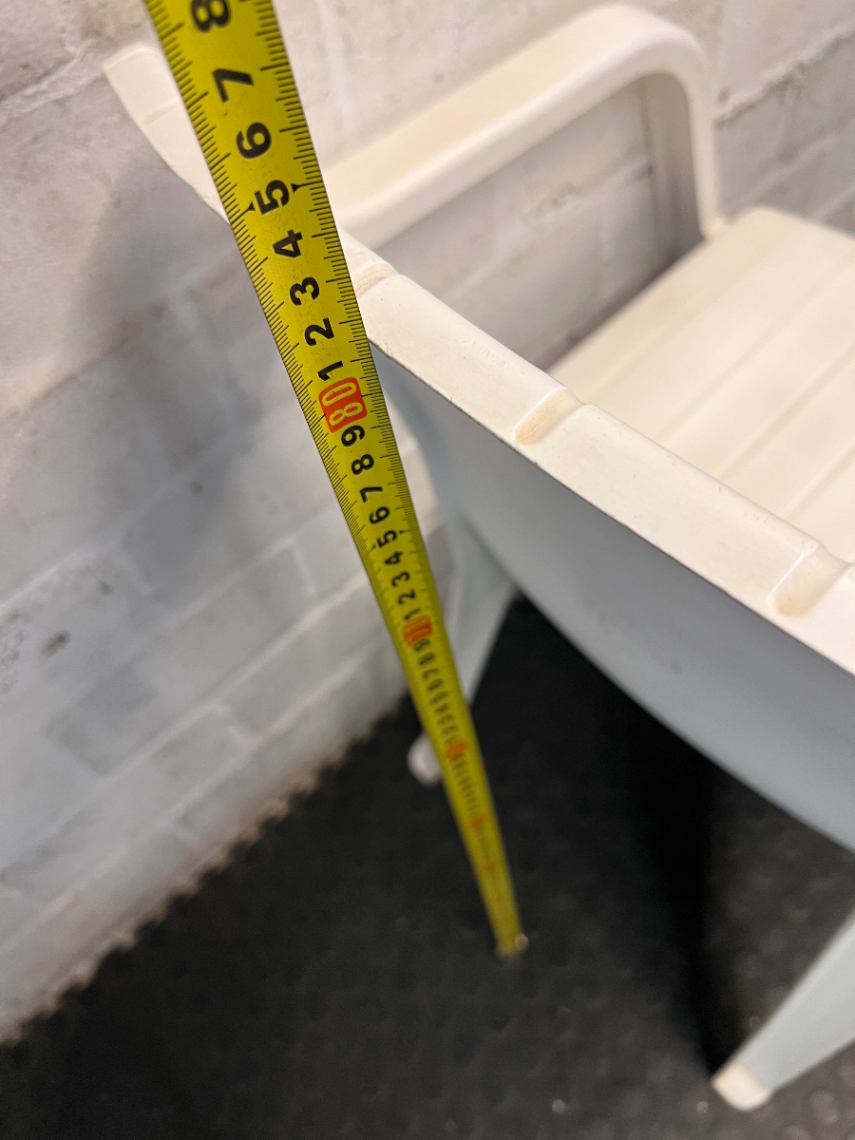 White Moulded Plastic Outdoor Armchair — Surface Wear and Cracks
