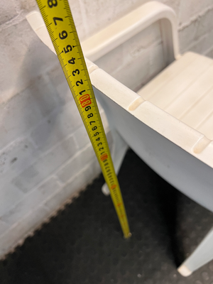 White Moulded Plastic Outdoor Armchair — Surface Wear and Cracks