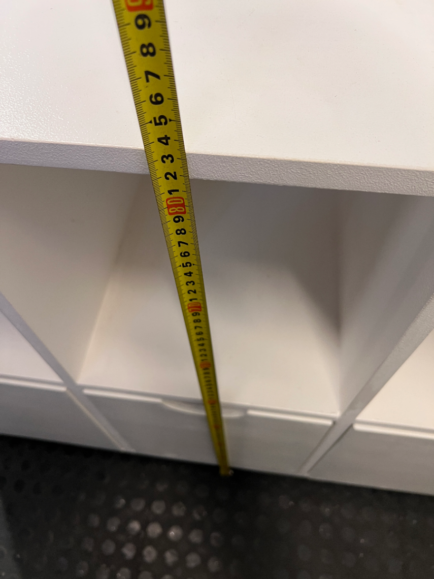 White Storage Cabinet with 4 Drawers and Wood Legs — Small Mark on One Drawer Face