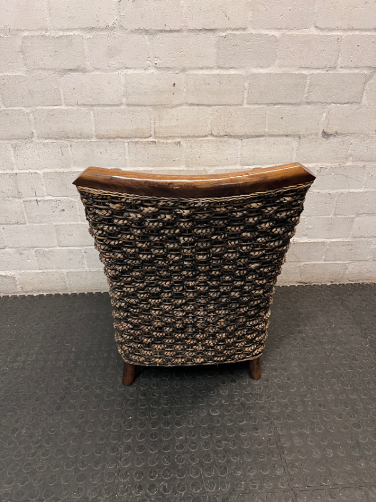 Woven Wicker and Dark Wood Armchair — Fair Used Condition with Faded Cushion
