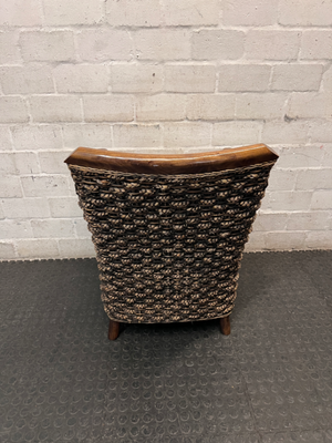 Woven Wicker and Dark Wood Armchair — Fair Used Condition with Faded Cushion