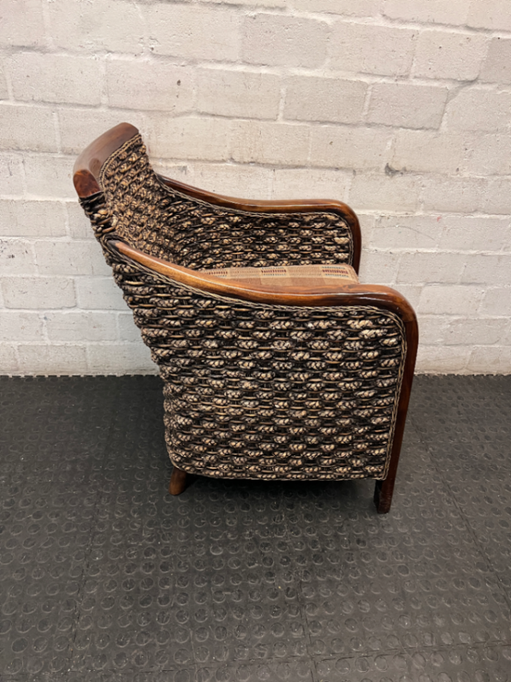 Woven Wicker and Dark Wood Armchair — Fair Used Condition with Faded Cushion