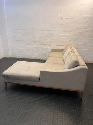 Neutral Fabric L-Shape Sectional Couch with Wooden Base — Well Used L-Shape Couch – side view