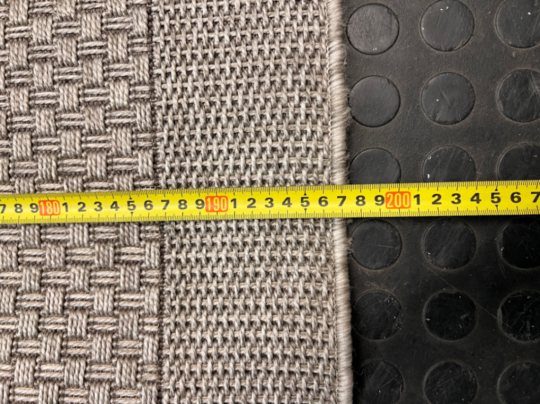 Large Woven Beige Area Rug — Well Used Rug – height measurement