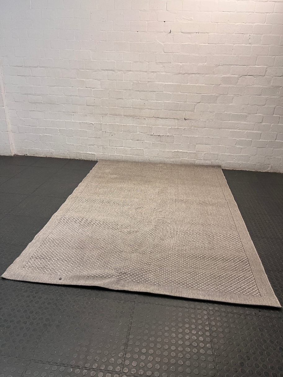 Large Woven Beige Area Rug — Well Used Rug – side view