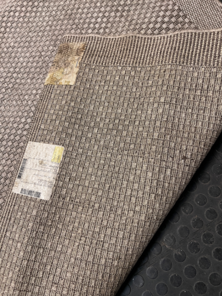 Large Woven Beige Area Rug — Well Used Rug – top view