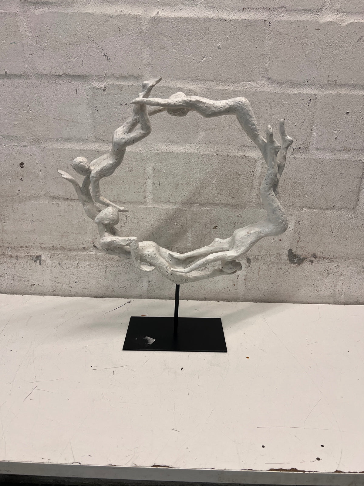 White Sculptural Figure Circle on Black Base — Used; Fair Condition – top view