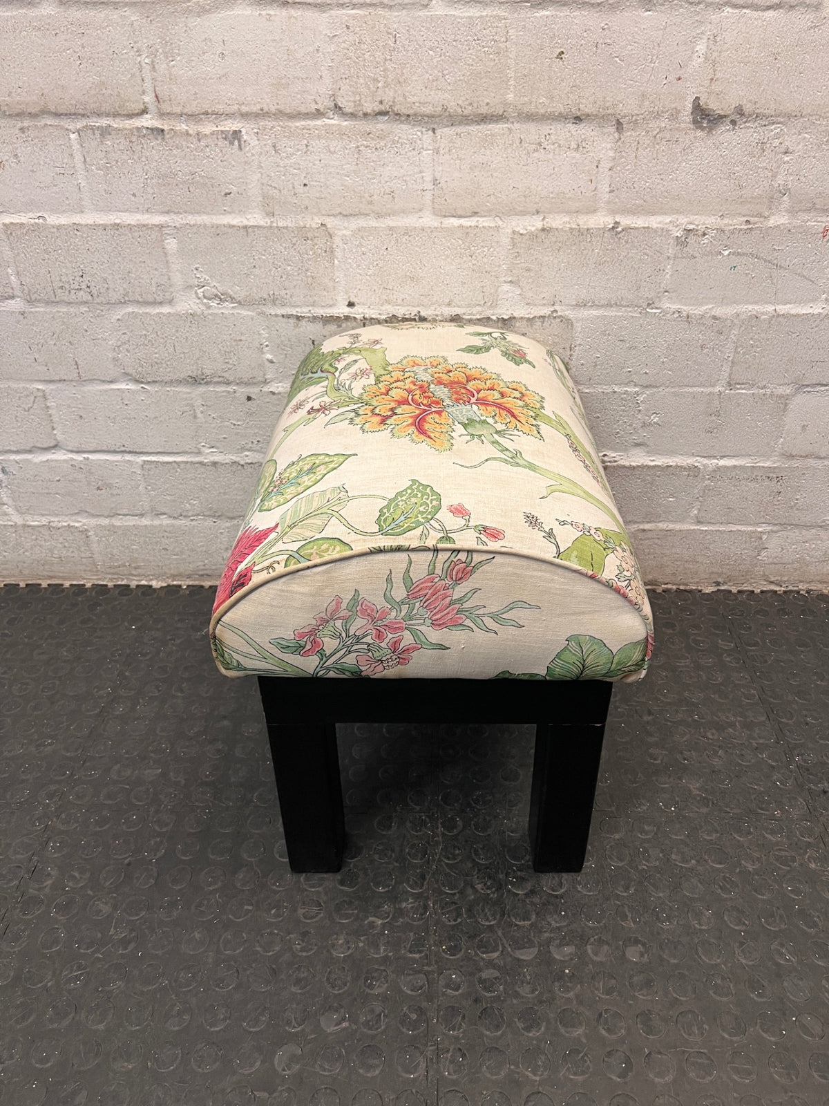 Floral Upholstered Ottoman with Black Timber Legs — Fair Condition With Visible Wear – back view
