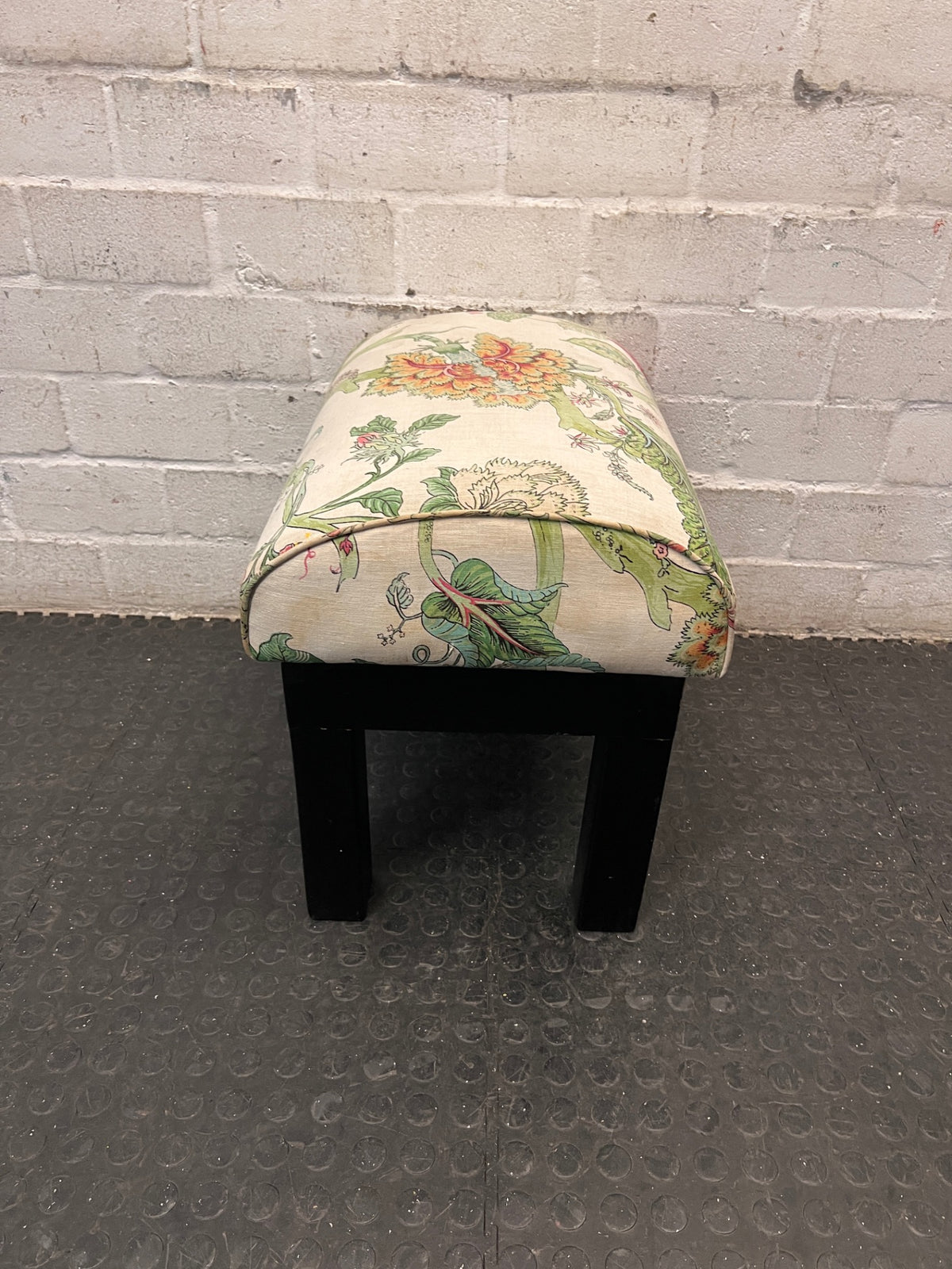 Floral Upholstered Ottoman with Black Timber Legs — Fair Condition With Visible Wear – side view