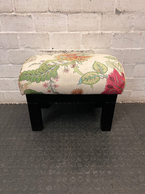 Floral Upholstered Ottoman with Black Timber Legs — Fair Condition With Visible Wear – top view