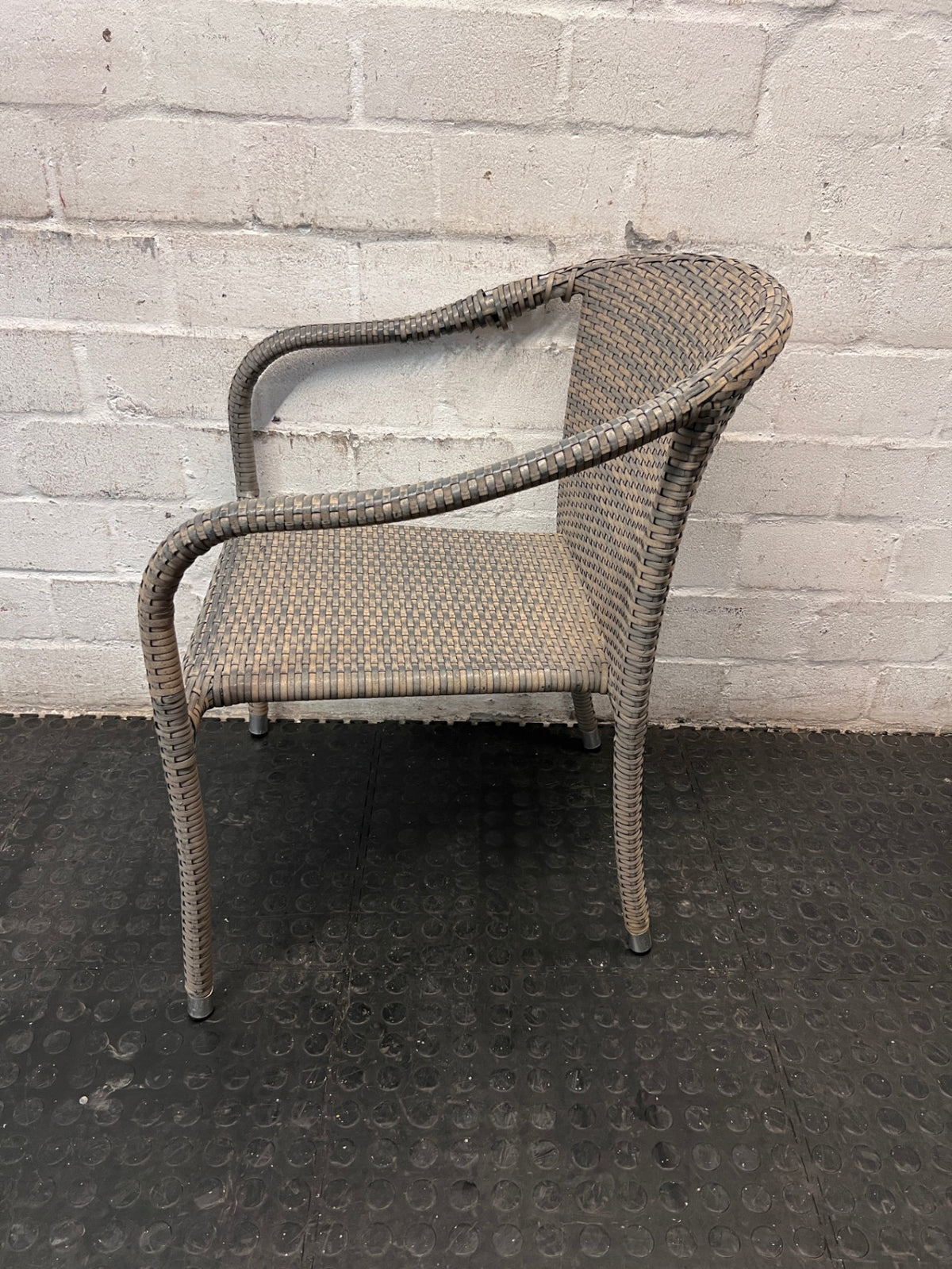 Grey Woven Synthetic Wicker Outdoor Chair — Well Used with Damaged Wicker Armrest – side view