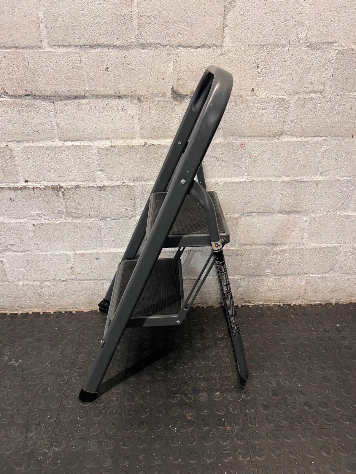 Strand 2-Step Folding Metal Ladder with Handrail — Well Used with Visible Wear – back view