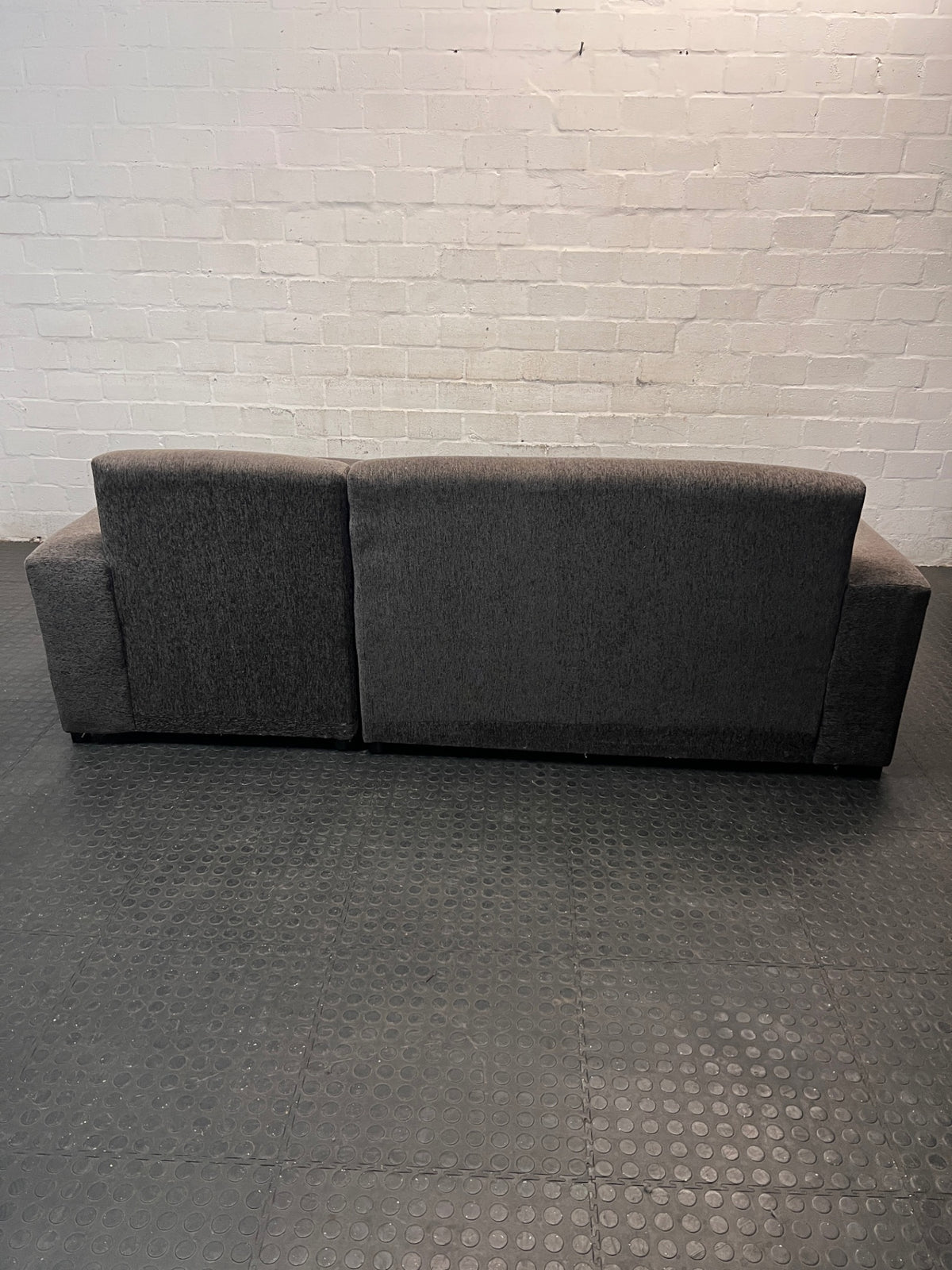 Grey Textured Fabric L-Shape Couch — Damaged and Worn Condition – back view