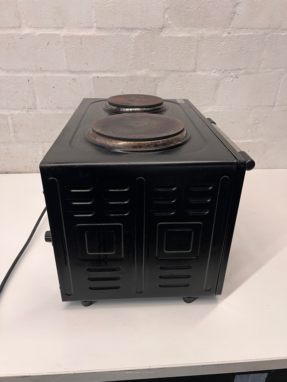 Black Fussion Two-Plate Countertop Stove and Oven — Working Order with Visible Rust – back view