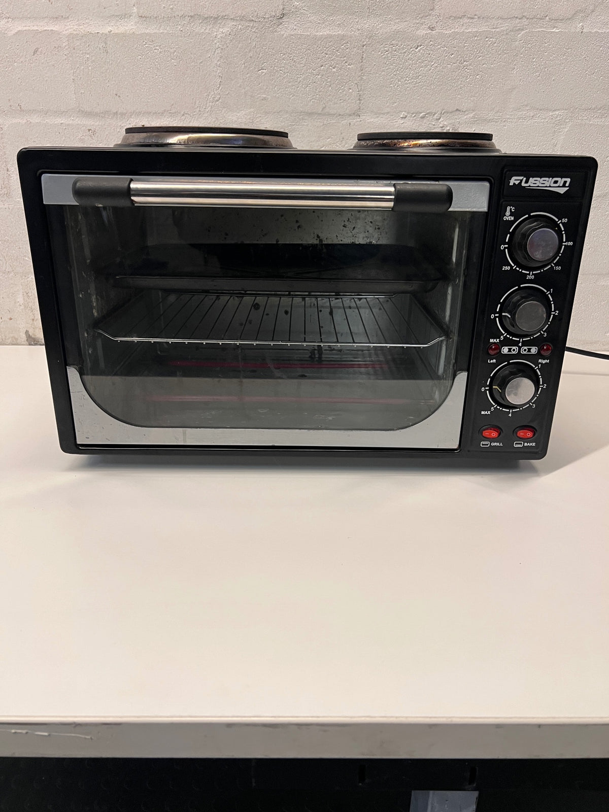 Black Fussion Two-Plate Countertop Stove and Oven — Working Order with Visible Rust – main front view