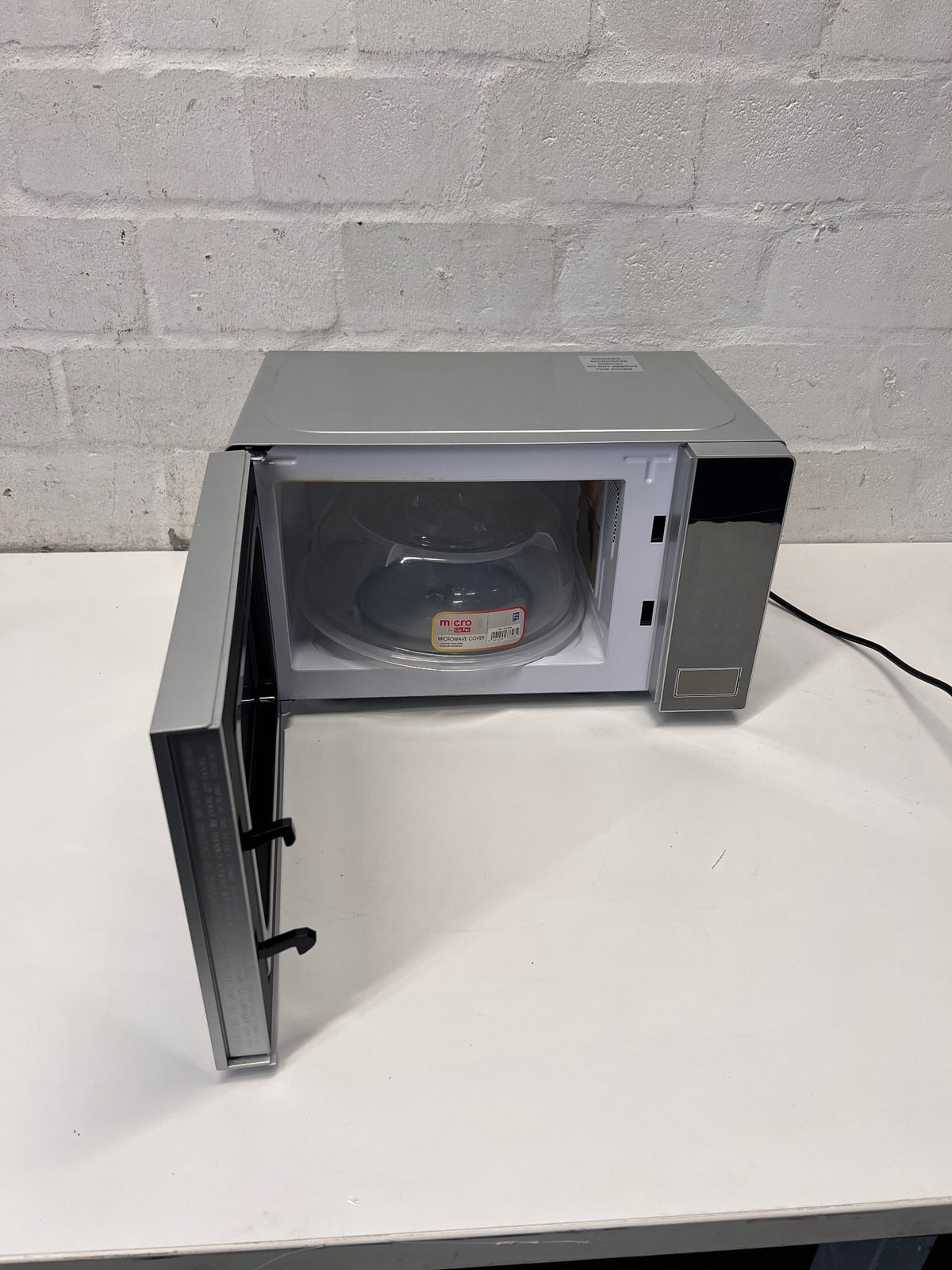 Hisense Silver Countertop Microwave with Mirrored Door — Good Working Order; Used Fair Condition – side view