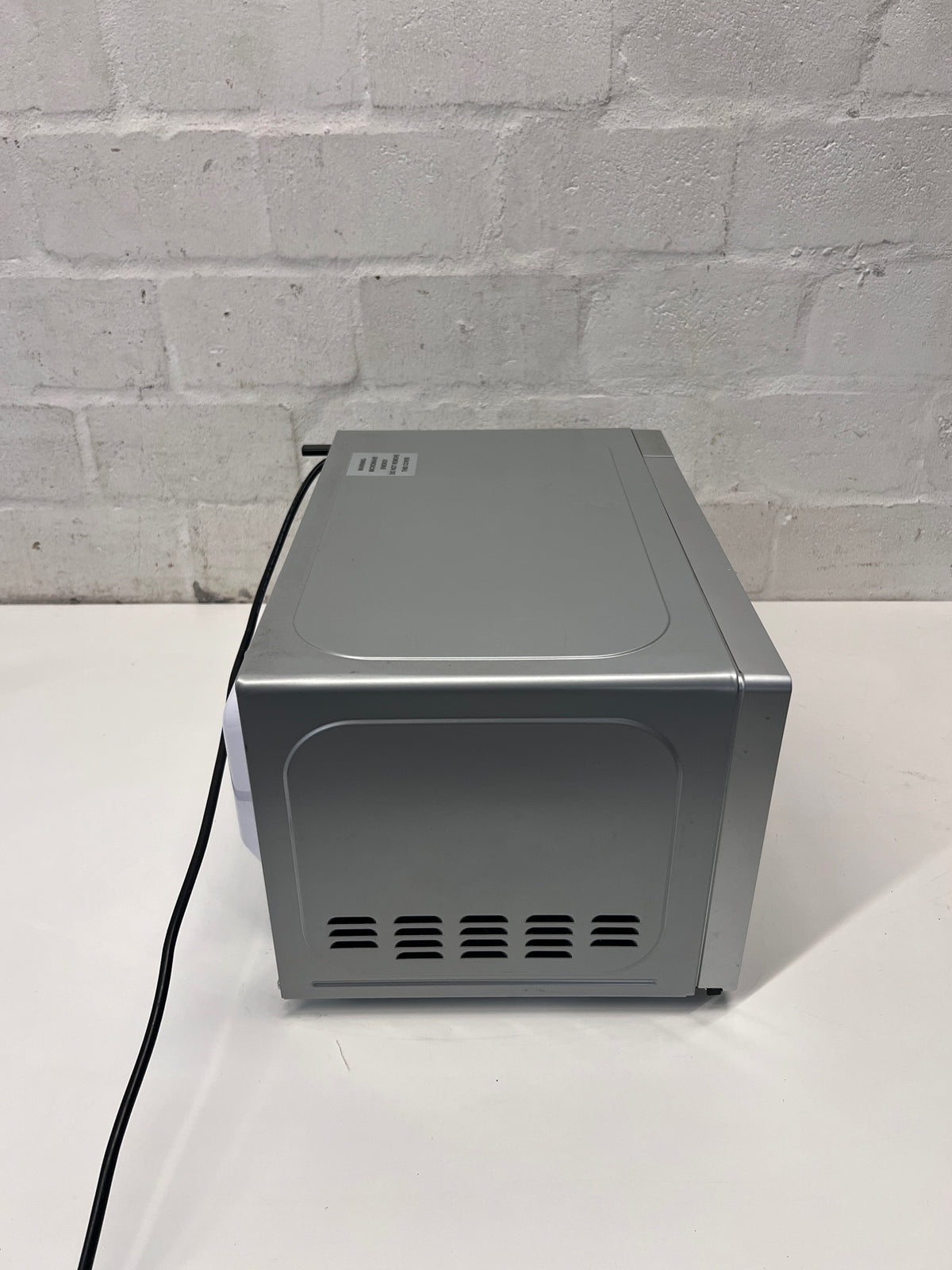 Hisense Silver Countertop Microwave with Mirrored Door — Good Working Order; Used Fair Condition – top view