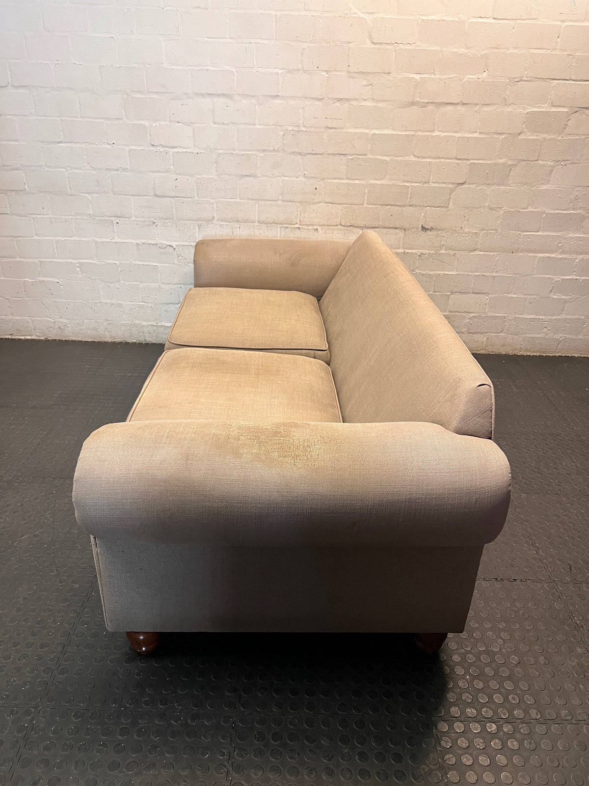 Grey Upholstered Two-Seater Couch with Rolled Arms — Good to Fair Condition with Marks on Armrest – back view