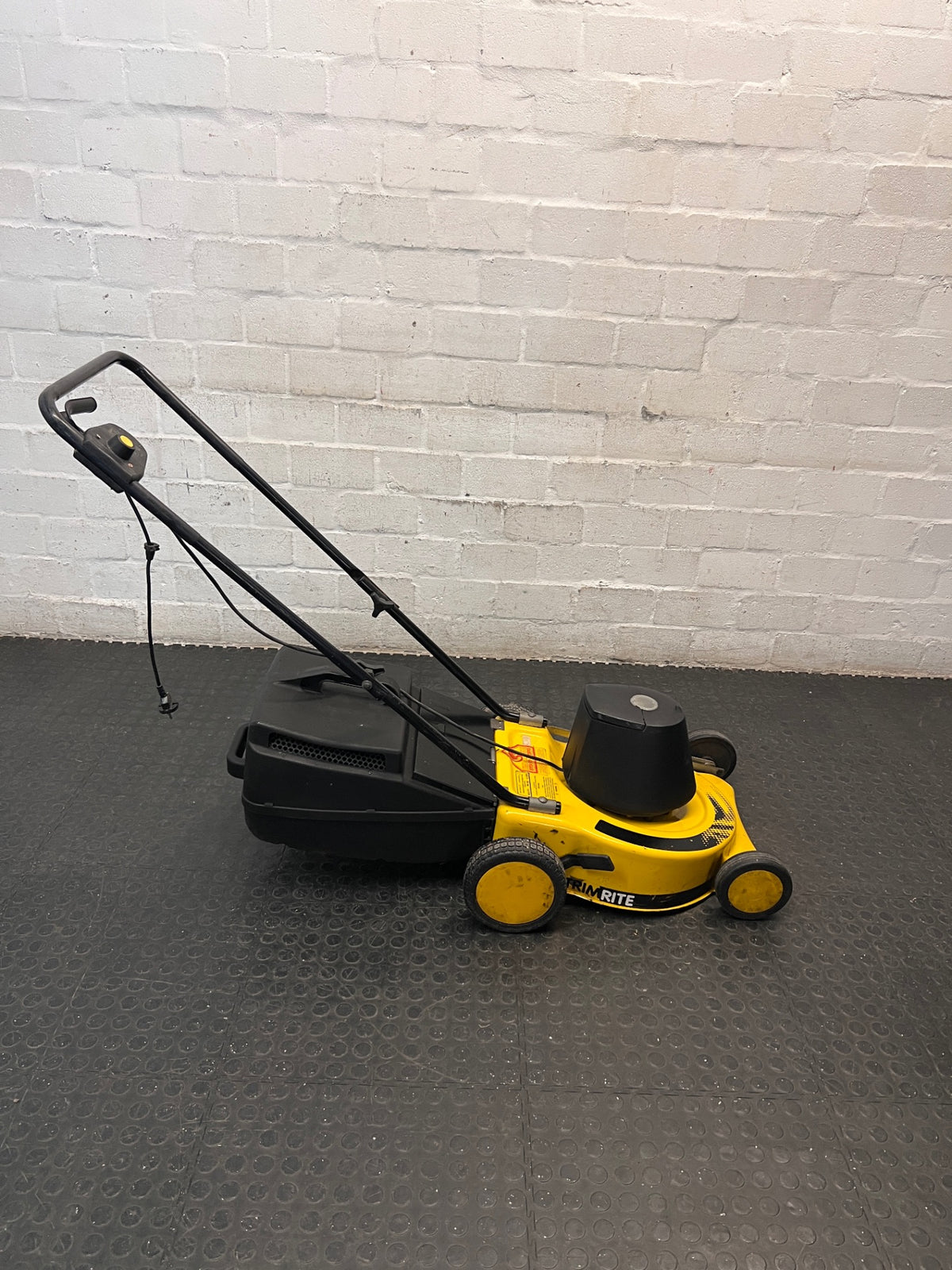 Electric Rotary Lawnmower in Yellow and Black — Trips Power Supply; Non-Functional – side view