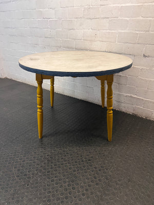 Round Yellow Wood Outdoor Table with Blue Trim — Visible Wear and Surface Staining – side view