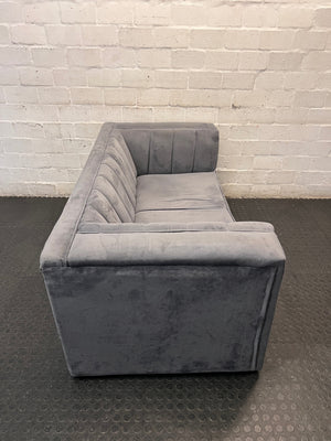 Grey Two Seater Couch with Vertical Stitching — Upholstery Has Wear and Tear – back view