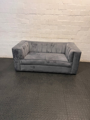 Grey Two Seater Couch with Vertical Stitching — Upholstery Has Wear and Tear – main front view