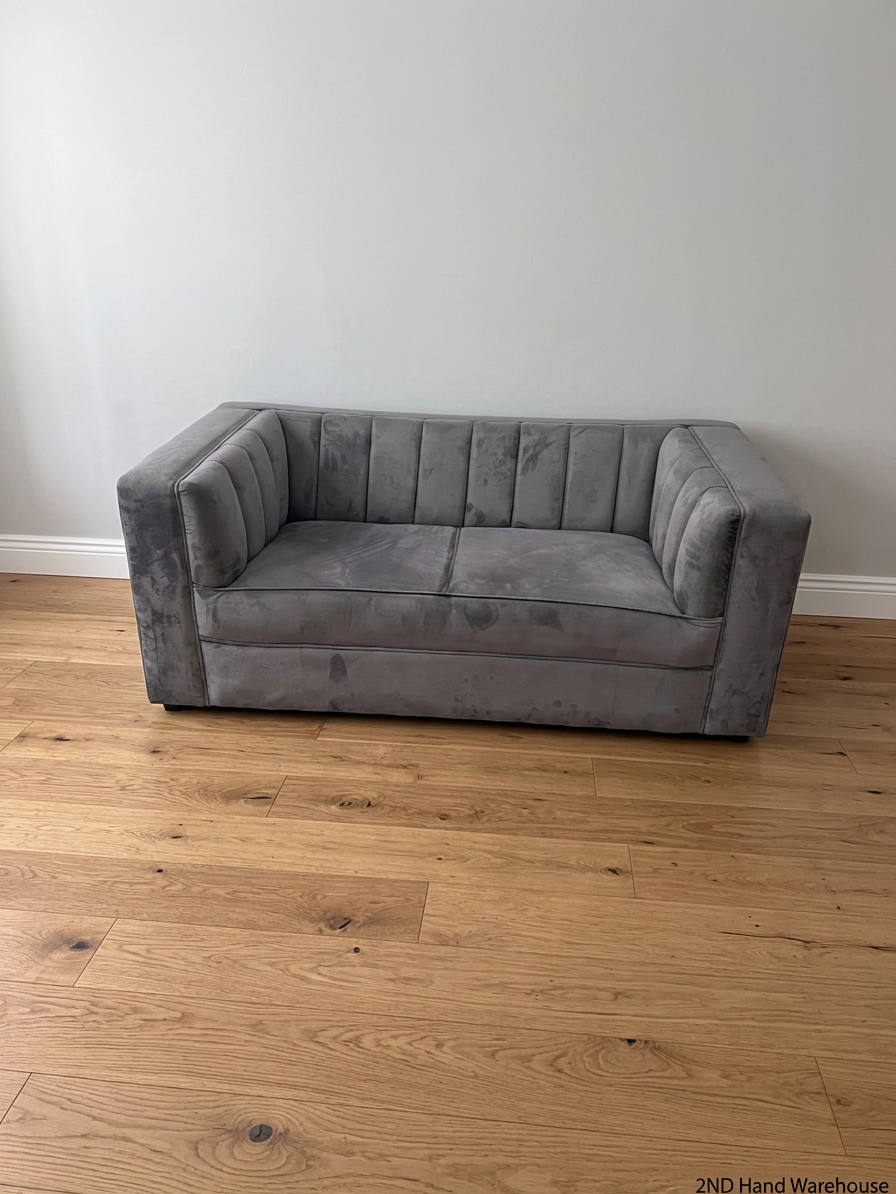 Grey Two Seater Couch with Vertical Stitching — Upholstery Has Wear and Tear – styled product image