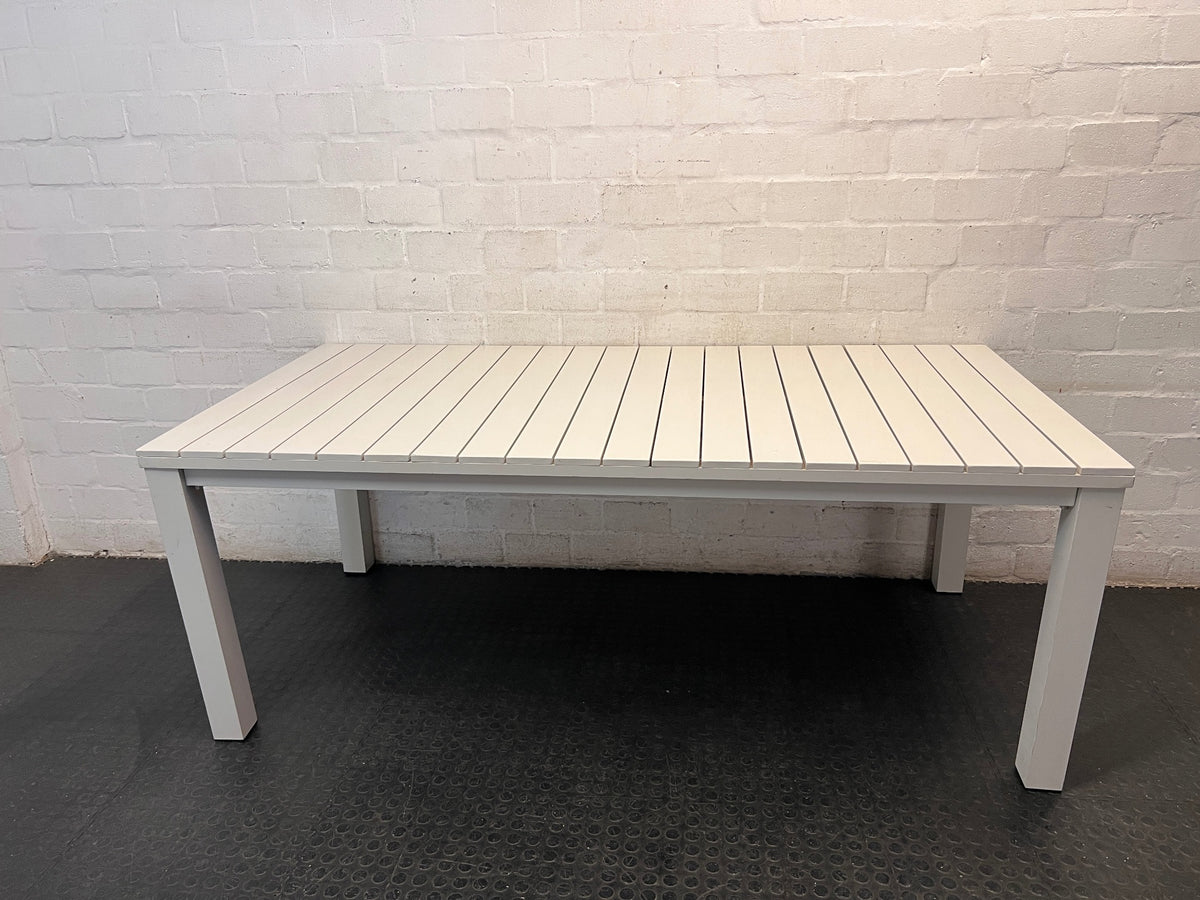 Cream Slatted Metal Outdoor Table — Well Used with General Outdoor Wear – main front view