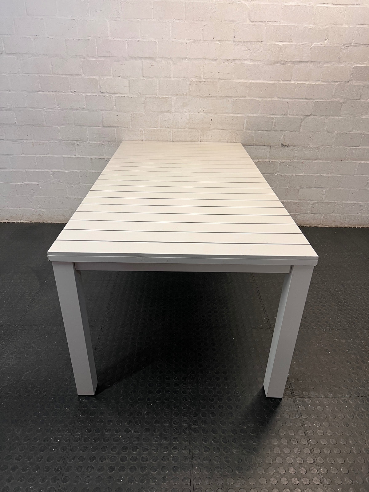 Cream Slatted Metal Outdoor Table — Well Used with General Outdoor Wear – side view