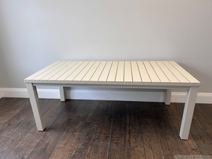 Cream Slatted Metal Outdoor Table — Well Used with General Outdoor Wear – styled product image