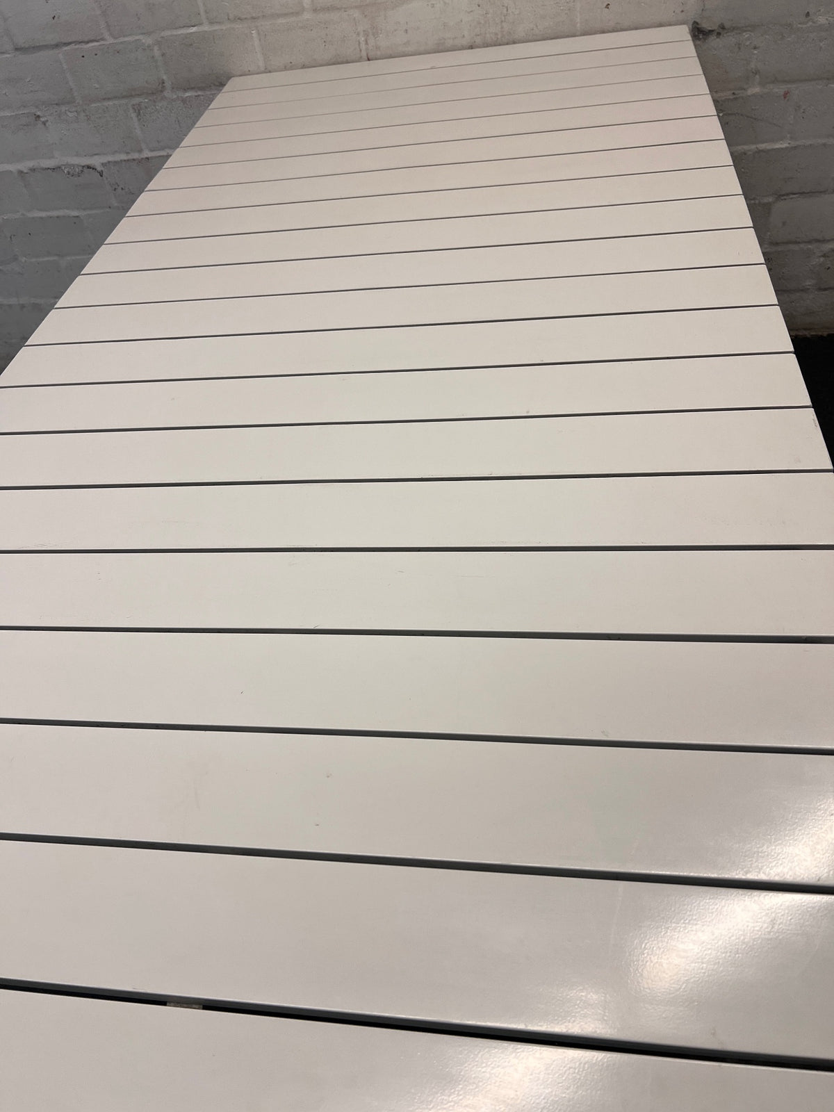 Cream Slatted Metal Outdoor Table — Well Used with General Outdoor Wear – top view