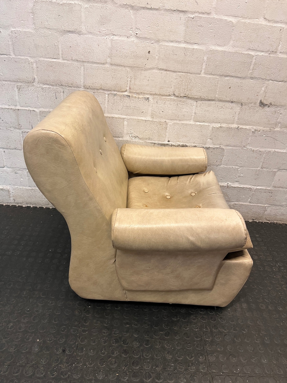 Beige Button-Tufted One Seater Couch with Bolster Arms — Damaged Upholstery and Missing Buttons – back view