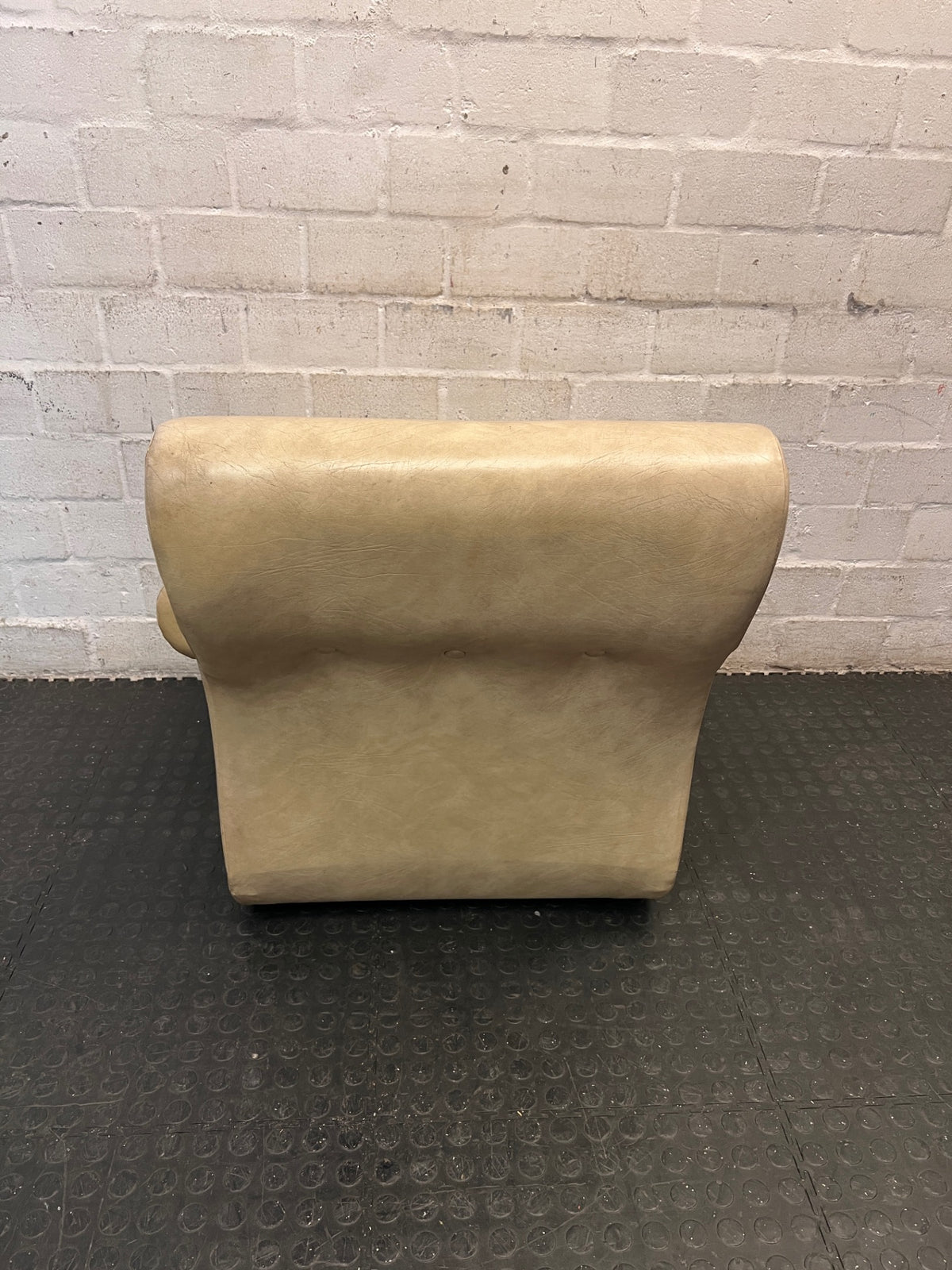 Beige Button-Tufted One Seater Couch with Bolster Arms — Damaged Upholstery and Missing Buttons – condition detail