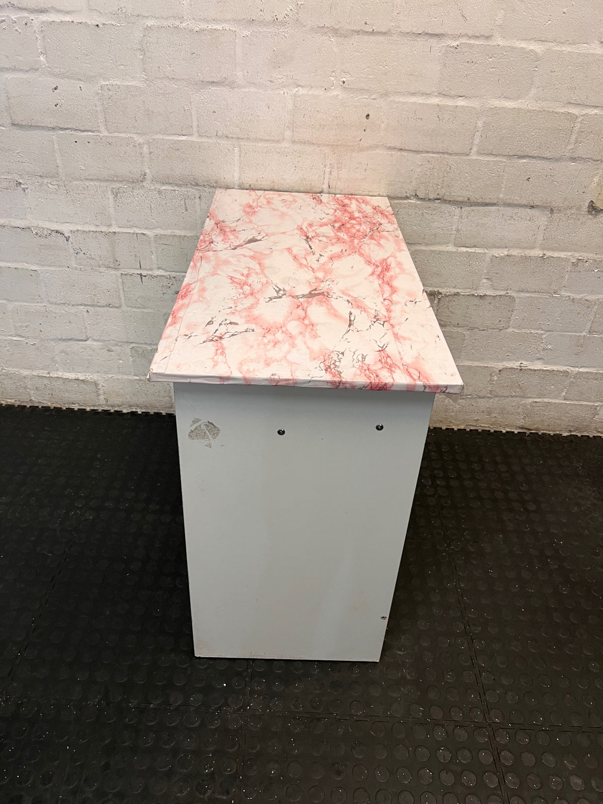 White Office Desk with Marble Pattern Top — Damaged Surface and Fair Condition – side view