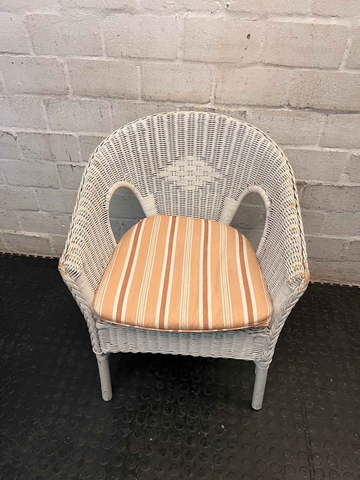 White Wicker Armchair with Striped Cushion — Wicker Coming Undone on Chair Back – main front view