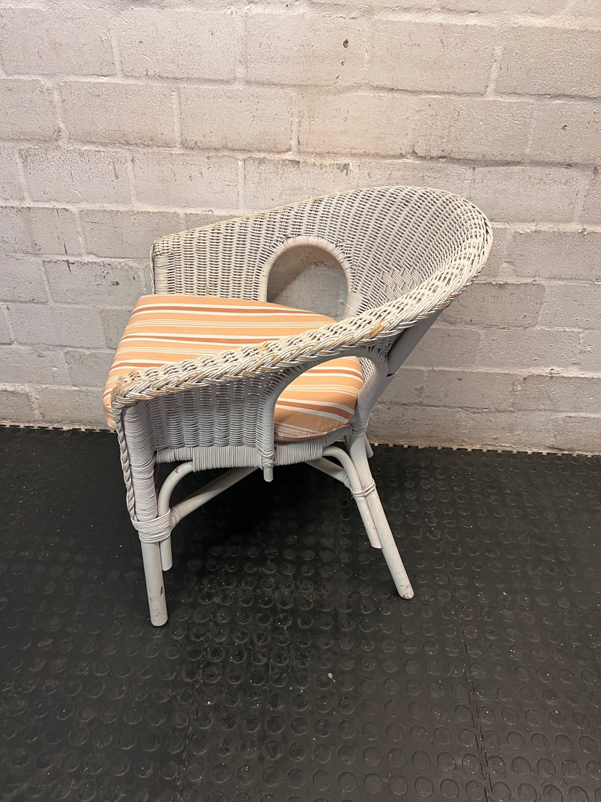 White Wicker Armchair with Striped Cushion — Wicker Coming Undone on Chair Back – side view