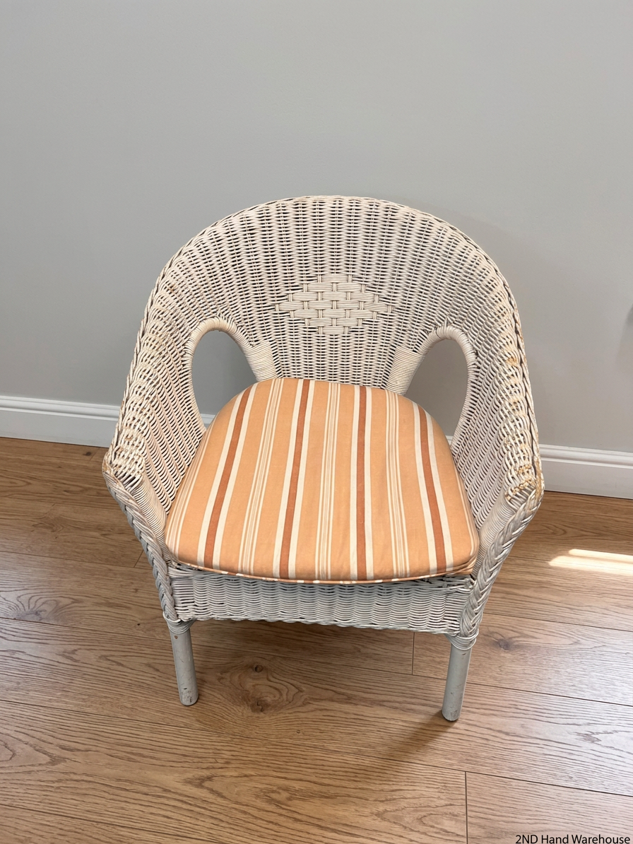 White Wicker Armchair with Striped Cushion — Wicker Coming Undone on Chair Back – styled product image