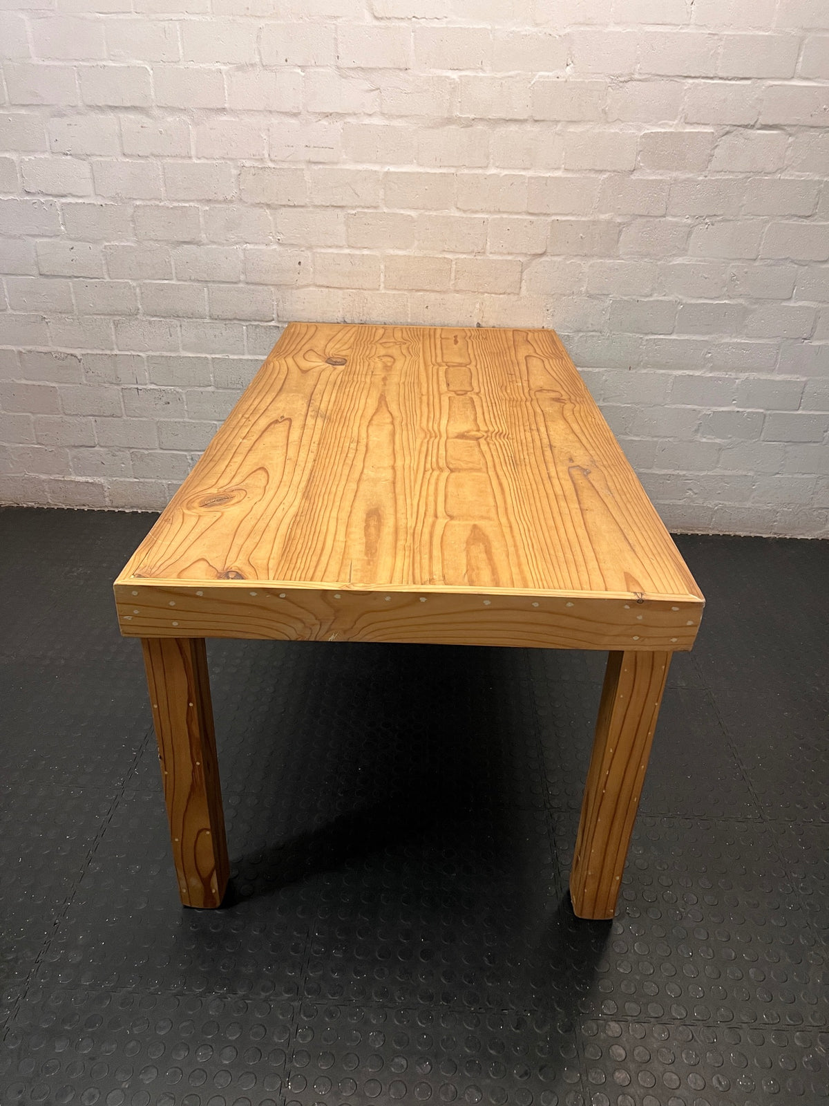 Rustic Oak-Tone Wooden Dining and Work Table — Unfinished Wood with Paint Splatter and Water Rings – back view