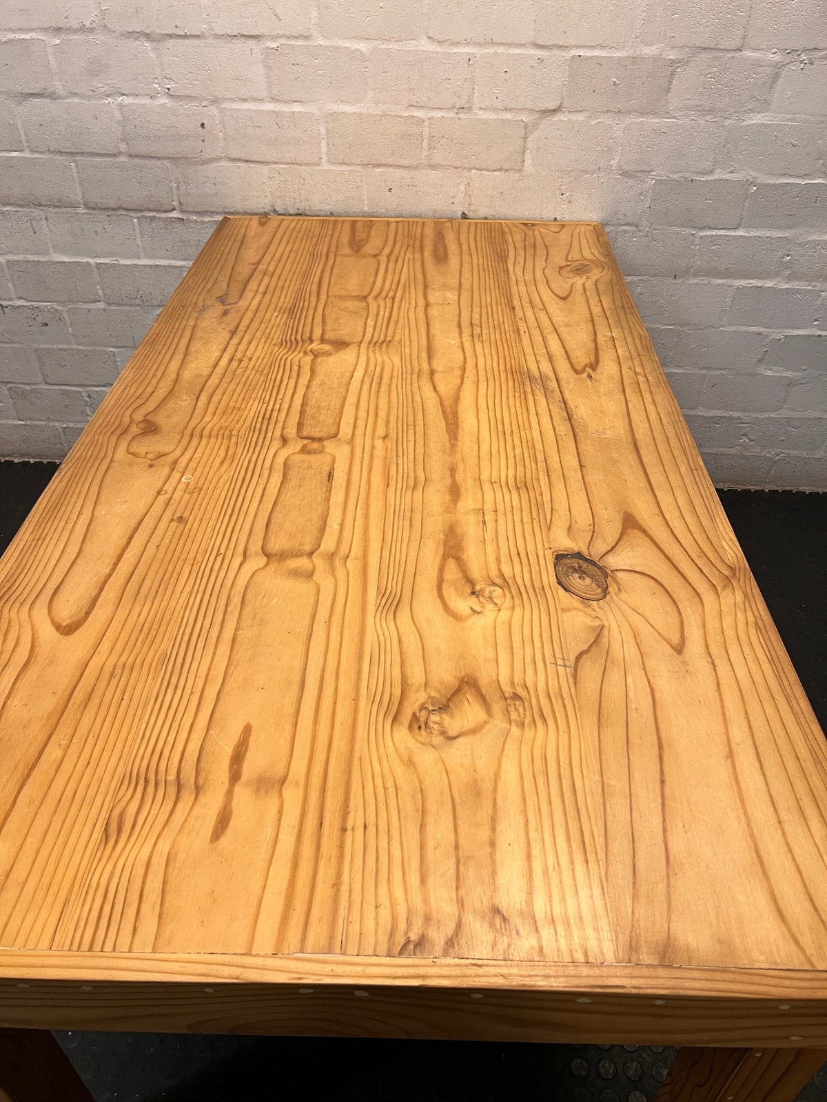 Rustic Oak-Tone Wooden Dining and Work Table — Unfinished Wood with Paint Splatter and Water Rings – top view