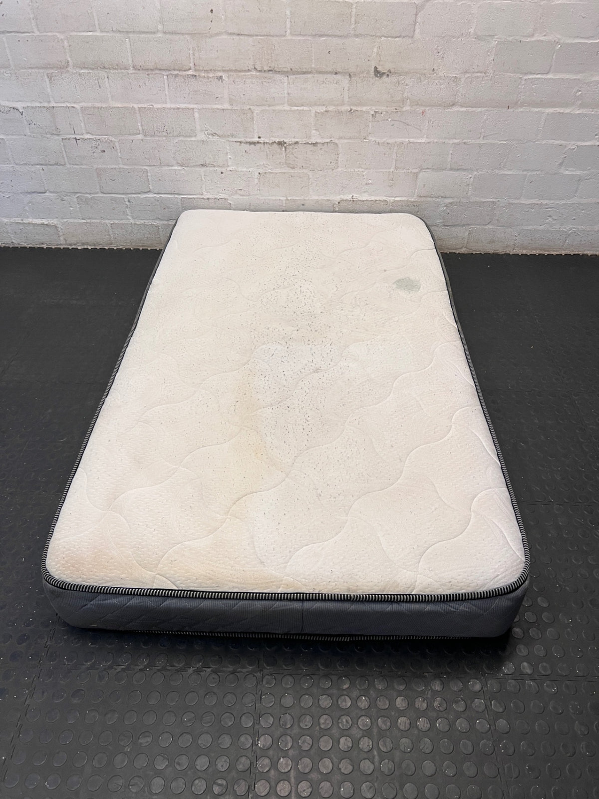 Single White and Grey Quilted Mattress — Surface Burn Mark and Water Damage – top view