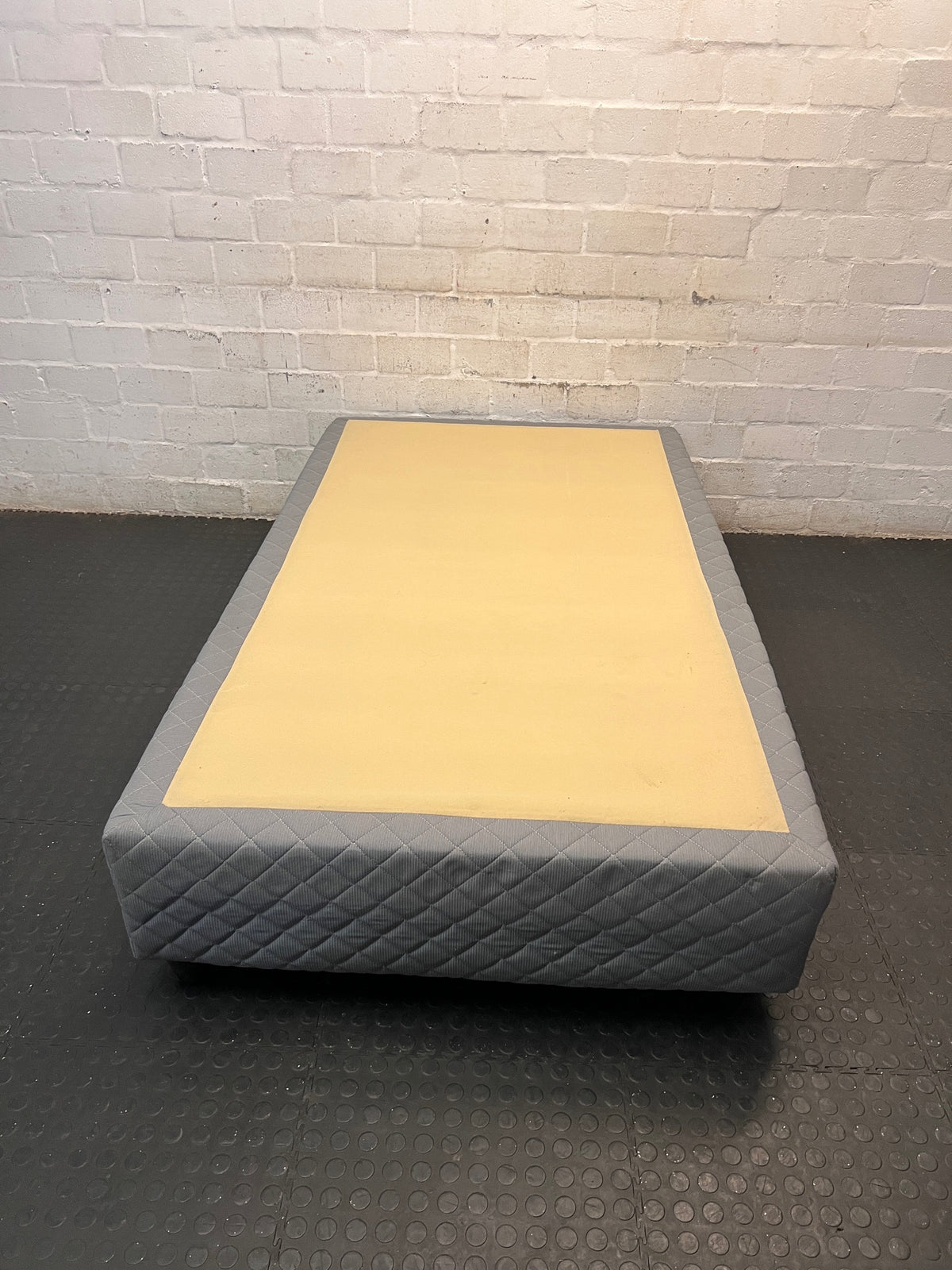 Quilted Grey Upholstered Single Bed Base — Loose Bottom Ring and Well-Used Condition – condition detail
