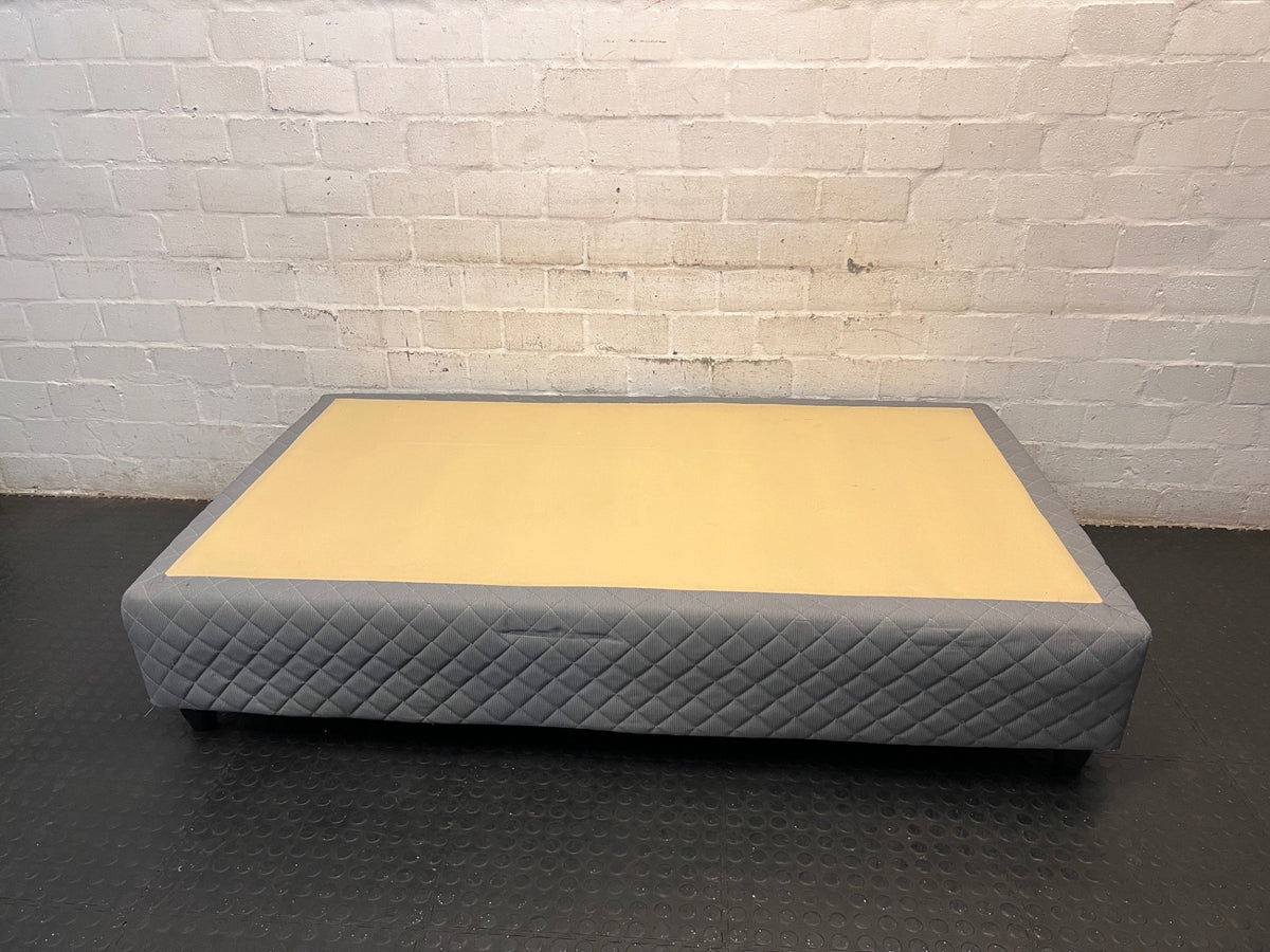 Quilted Grey Upholstered Single Bed Base — Loose Bottom Ring and Well-Used Condition – side view
